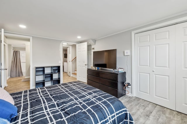 bedroom with recessed lighting, a closet, wood finished floors, and ornamental molding