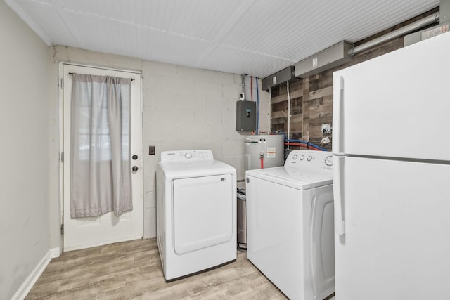 clothes washing area with concrete block wall, independent washer and dryer, light wood-style flooring, laundry area, and electric panel