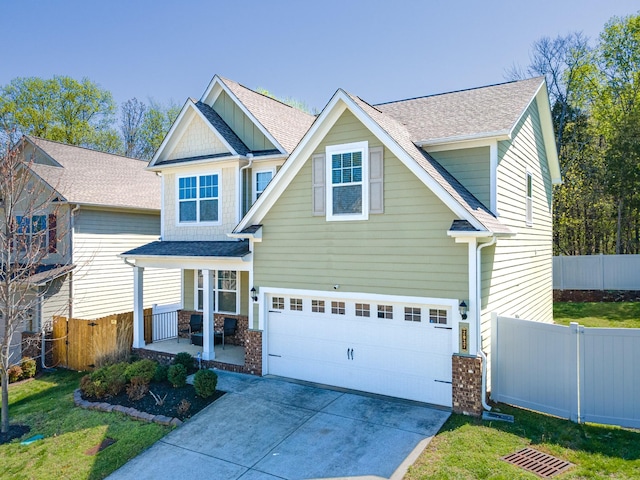 2037 Hamilton Hill Dr, Antioch, TN 37013 - craftsman house featuring concrete driveway, covered porch, an attached garage, fence, and roof with shingles