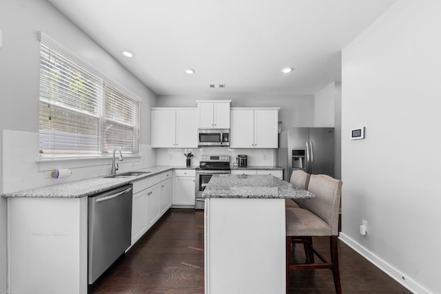 2037 Hamilton Hill Dr, Antioch, TN 37013 - kitchen with a sink, decorative backsplash, stainless steel appliances, a kitchen bar, and a kitchen island