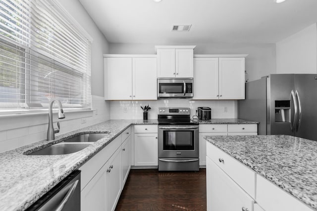 2037 Hamilton Hill Dr, Antioch, TN 37013 - kitchen featuring white cabinets, stainless steel appliances, dark wood-style floors, a sink, and tasteful backsplash