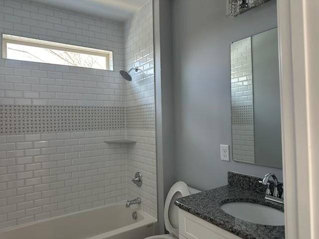 bathroom featuring toilet, vanity, and tub / shower combination