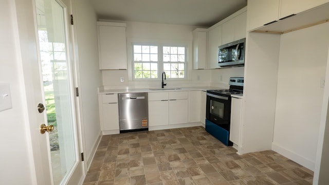 259 W End Hts, Lebanon, TN 37087 - kitchen with light countertops, white cabinetry, a sink, stone finish flooring, and stainless steel appliances