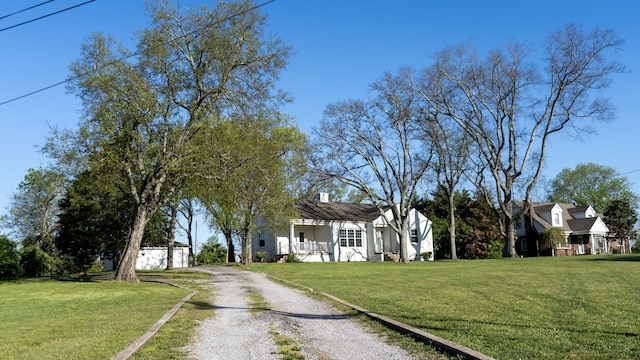 259 W End Hts, Lebanon, TN 37087 - view of front facade featuring dirt driveway, a front lawn, an outbuilding, and covered porch