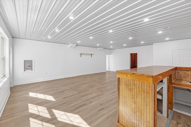 interior space featuring light wood-style flooring and baseboards