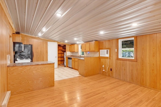kitchen featuring light wood-type flooring, wooden walls, and stainless steel dishwasher