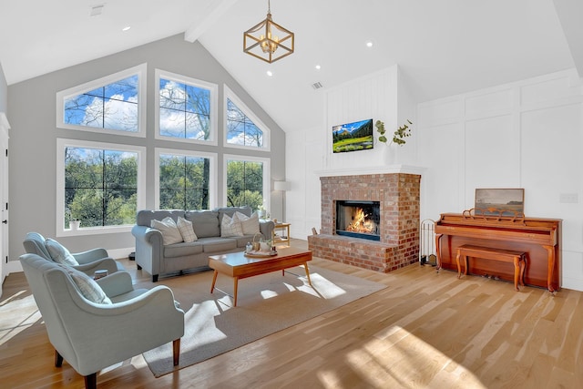 1017 Cliff View Dr N, Kingston Springs, TN 37082 - living room with a decorative wall, light wood finished floors, visible vents, and beamed ceiling