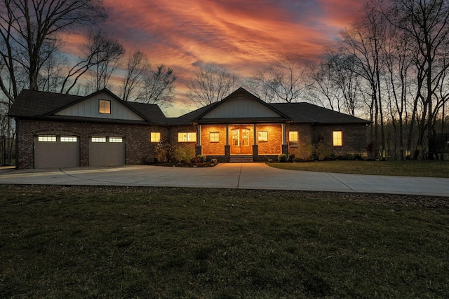 1017 Cliff View Dr N, Kingston Springs, TN 37082 - view of front facade featuring brick siding, concrete driveway, a front yard, and a garage