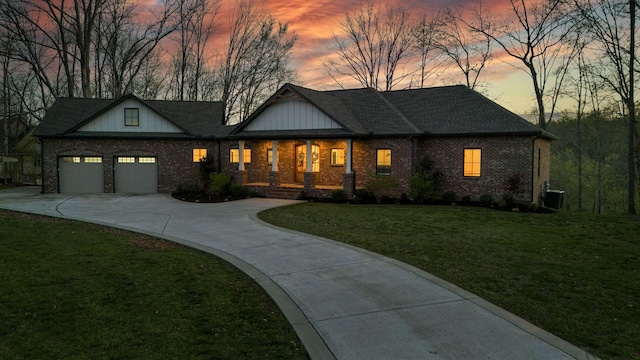 1017 Cliff View Dr N, Kingston Springs, TN 37082 - view of front of home with a porch, a garage, brick siding, a front lawn, and driveway