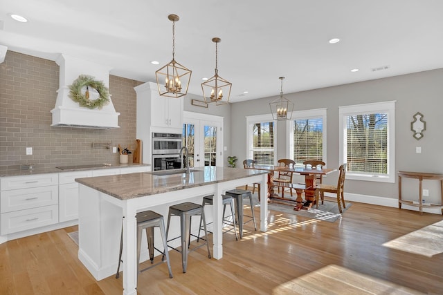 1017 Cliff View Dr N, Kingston Springs, TN 37082 - kitchen featuring light wood-style floors, visible vents, double oven, and black electric cooktop