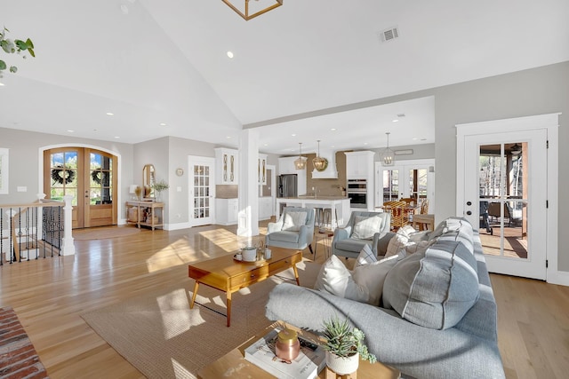 1017 Cliff View Dr N, Kingston Springs, TN 37082 - living area featuring visible vents, french doors, high vaulted ceiling, and light wood-style floors