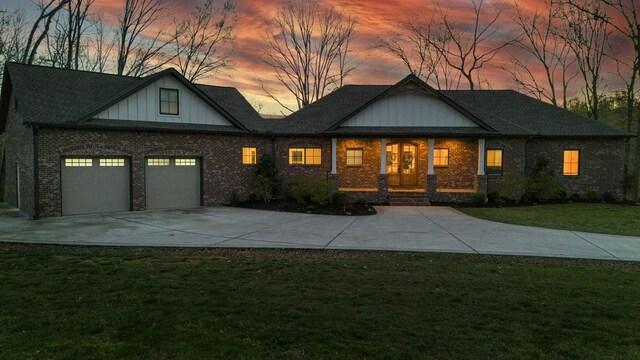 1017 Cliff View Dr N, Kingston Springs, TN 37082 - view of front of property with driveway, a front lawn, a porch, brick siding, and a garage