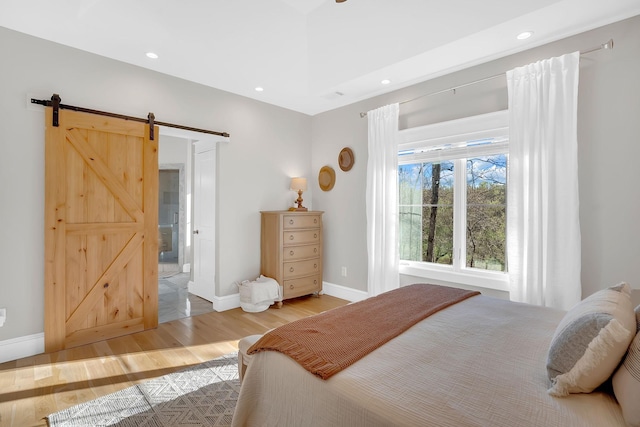 1017 Cliff View Dr N, Kingston Springs, TN 37082 - bedroom featuring light wood-style flooring, recessed lighting, baseboards, and a barn door