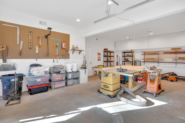 1017 Cliff View Dr N, Kingston Springs, TN 37082 - garage featuring visible vents and a workshop area