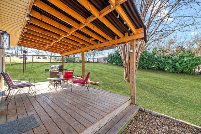 wooden deck with grilling area, fence, and a yard