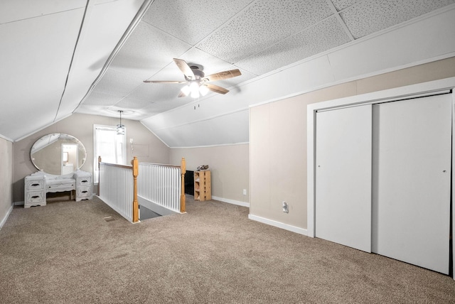 bonus room featuring lofted ceiling, a ceiling fan, baseboards, and carpet floors