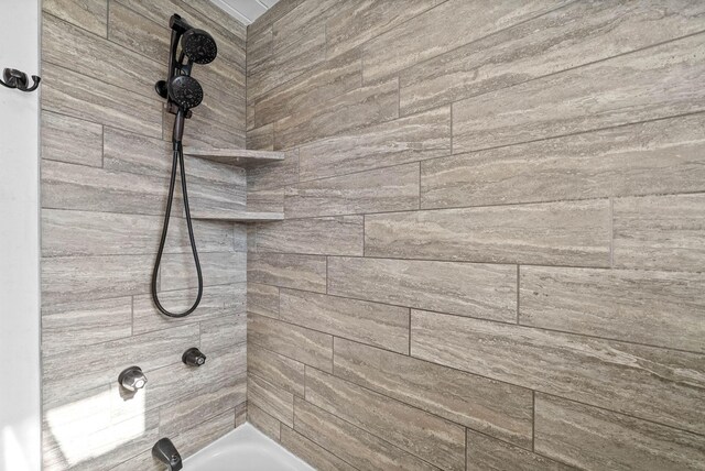 interior details featuring shower / tub combination