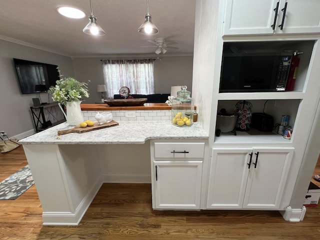 22 Jean Dr, Carthage, TN 37030 - kitchen with black microwave, crown molding, ceiling fan, white cabinetry, and a peninsula