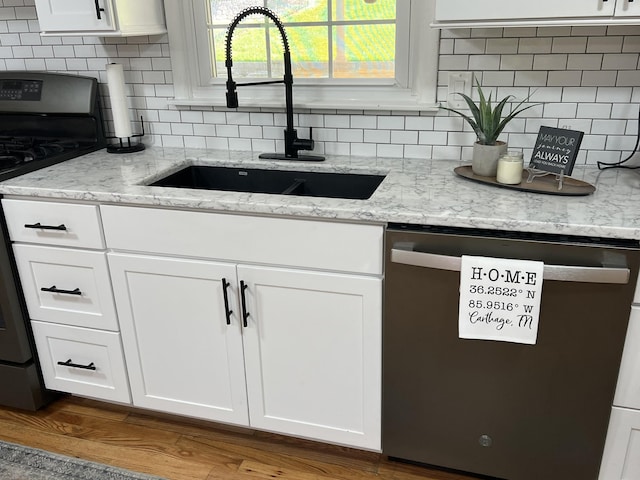 22 Jean Dr, Carthage, TN 37030 - kitchen with stainless steel dishwasher, a sink, stove, and decorative backsplash