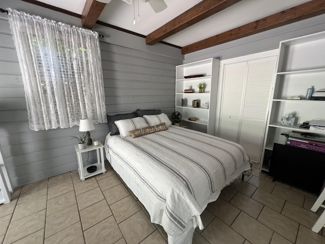 22 Jean Dr, Carthage, TN 37030 - bedroom featuring light tile patterned floors, beam ceiling, a closet, ceiling fan, and wooden walls