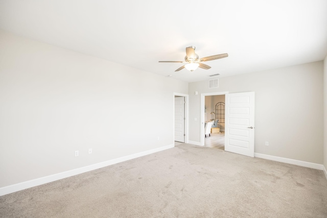 unfurnished bedroom with light carpet, baseboards, visible vents, and ceiling fan