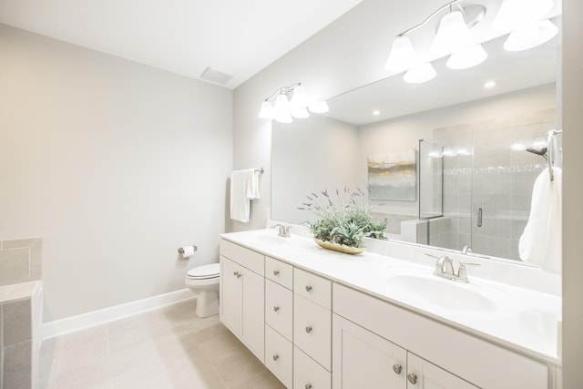 full bathroom featuring double vanity, a sink, toilet, and a shower stall