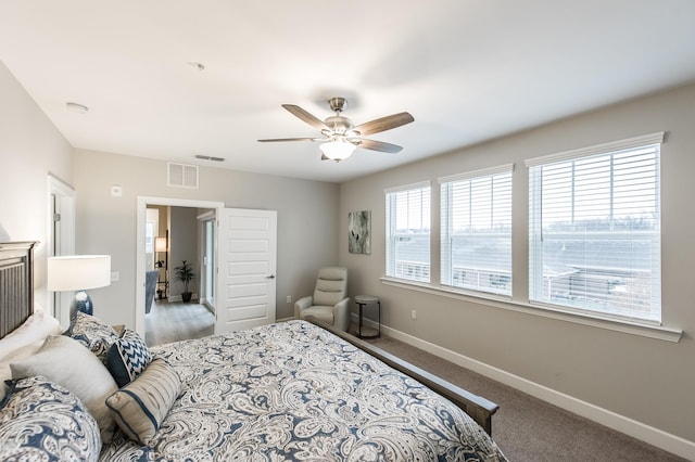 bedroom with baseboards, visible vents, and multiple windows