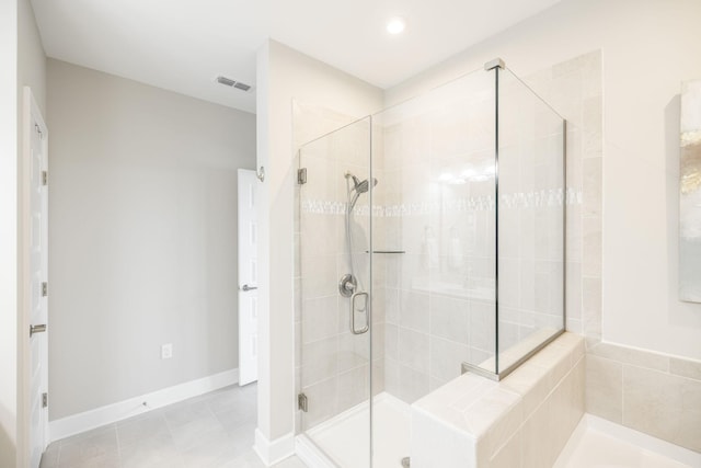 bathroom with a stall shower, baseboards, visible vents, and tile patterned floors