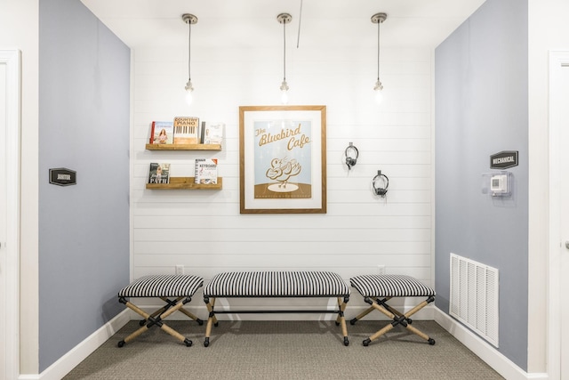 interior space with baseboards, visible vents, and carpet floors