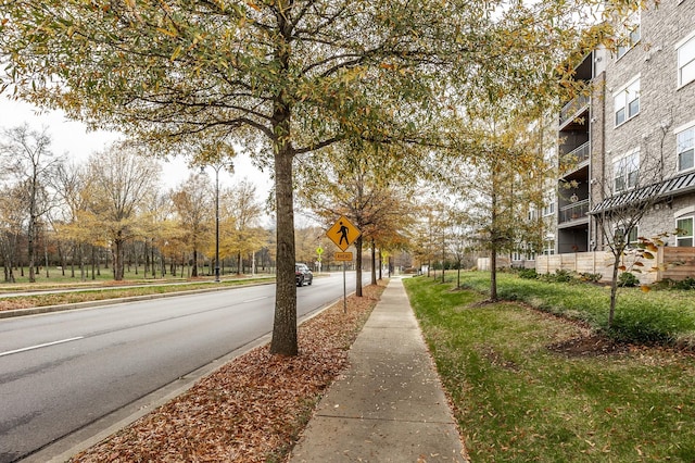 view of road featuring curbs, traffic signs, and sidewalks