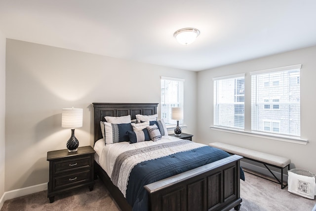 carpeted bedroom featuring baseboards