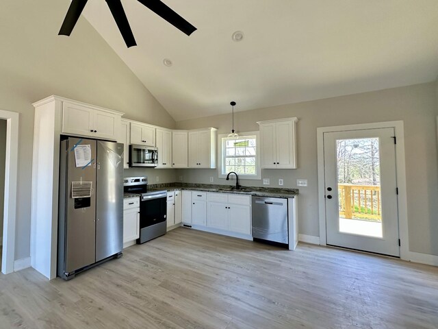 kitchen with ceiling fan, stainless steel appliances, white cabinetry, a sink, and light wood-type flooring