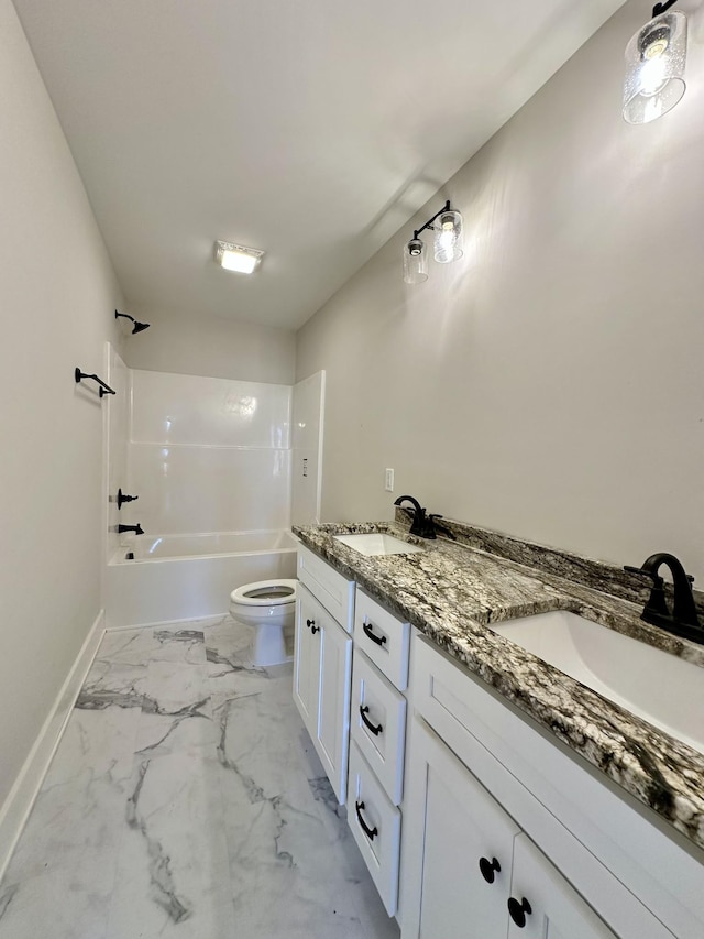 bathroom with marble finish floor, a sink, toilet, and tub / shower combination