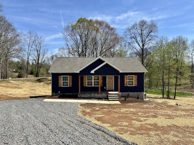 view of front facade featuring a porch and roof with shingles