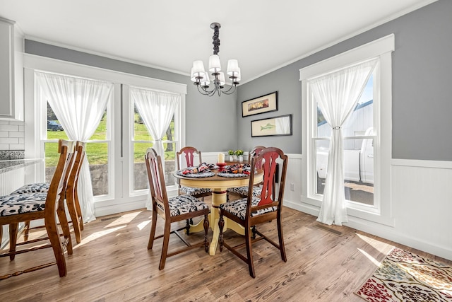 1036 Locke Creek Rd, Readyville, TN 37149 - dining space featuring a wainscoted wall, crown molding, a chandelier, light wood-style flooring, and visible vents