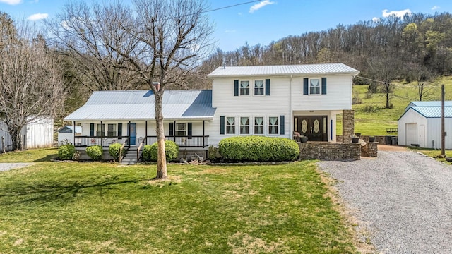 1036 Locke Creek Rd, Readyville, TN 37149 - view of front facade featuring covered porch, a front lawn, metal roof, and an outbuilding