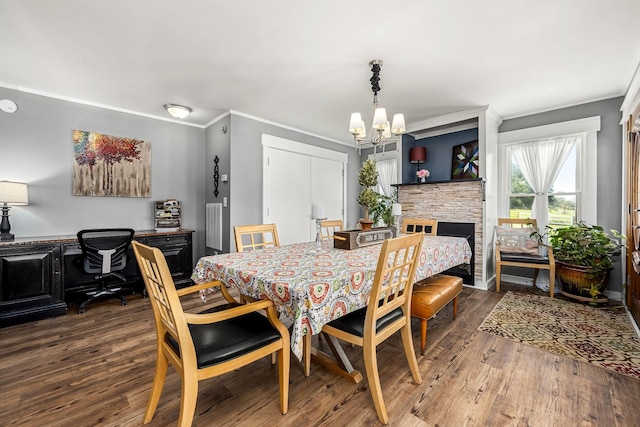 1036 Locke Creek Rd, Readyville, TN 37149 - dining area featuring a fireplace, wood finished floors, a chandelier, and crown molding