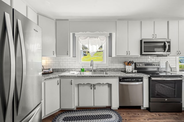 1036 Locke Creek Rd, Readyville, TN 37149 - kitchen featuring a sink, dark wood finished floors, stainless steel appliances, white cabinets, and decorative backsplash