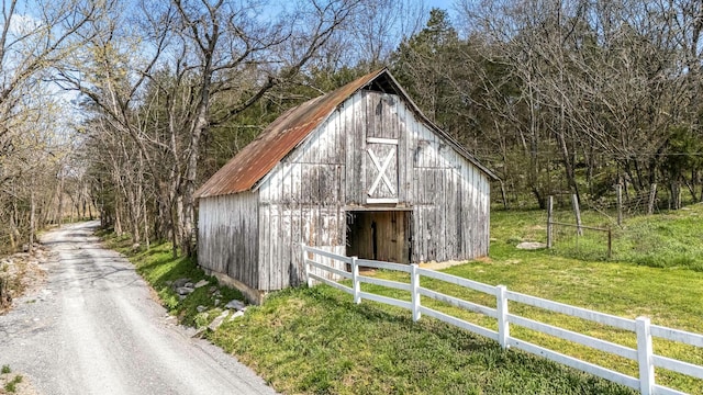 1036 Locke Creek Rd, Readyville, TN 37149 - view of barn with driveway, fence, and a yard