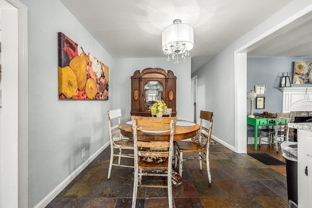 1036 Locke Creek Rd, Readyville, TN 37149 - dining area with baseboards, an inviting chandelier, and stone tile flooring