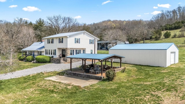 1036 Locke Creek Rd, Readyville, TN 37149 - rear view of house with an outdoor structure, a patio area, and a lawn