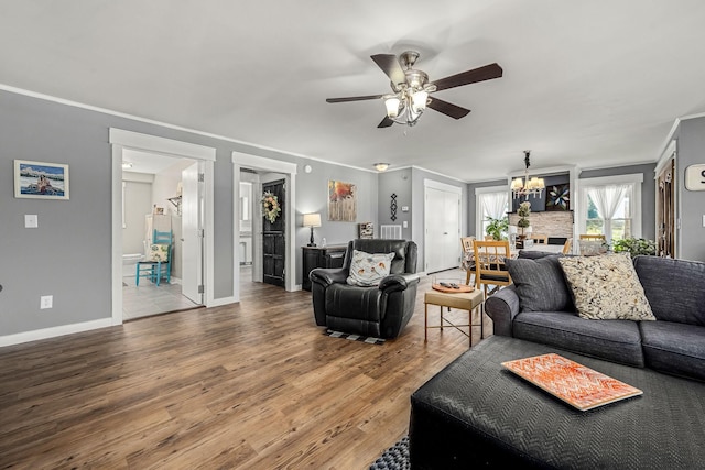 1036 Locke Creek Rd, Readyville, TN 37149 - living area featuring ceiling fan with notable chandelier, wood finished floors, baseboards, and ornamental molding