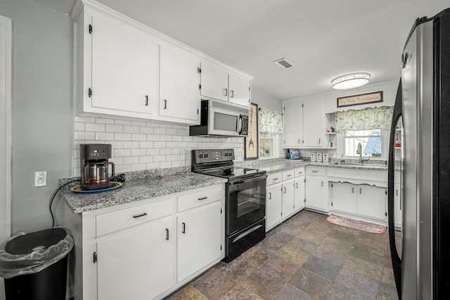 1036 Locke Creek Rd, Readyville, TN 37149 - kitchen featuring tasteful backsplash, a sink, freestanding refrigerator, white cabinets, and black range with electric stovetop