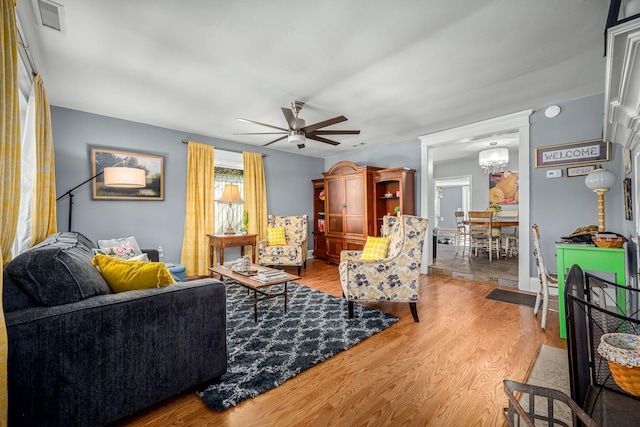 1036 Locke Creek Rd, Readyville, TN 37149 - living room featuring visible vents, wood finished floors, and ceiling fan with notable chandelier