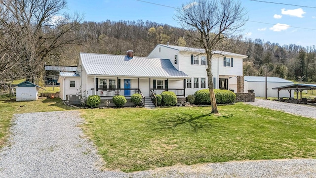 1036 Locke Creek Rd, Readyville, TN 37149 - traditional-style house with metal roof, a front yard, covered porch, and a chimney