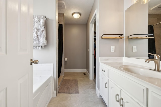 3648 S Jot Dr, Clarksville, TN 37040 - bathroom with a shower with curtain, vanity, a bath, and a textured ceiling