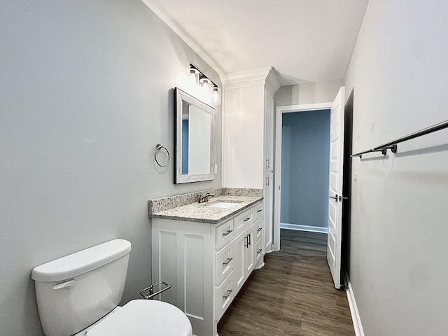 402 Pine St, Pulaski, TN 38478 - bathroom with vanity, toilet, baseboards, and wood finished floors