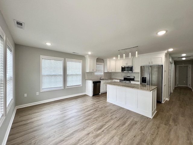 402 Pine St, Pulaski, TN 38478 - kitchen featuring stainless steel appliances, white cabinetry, plenty of natural light, and recessed lighting