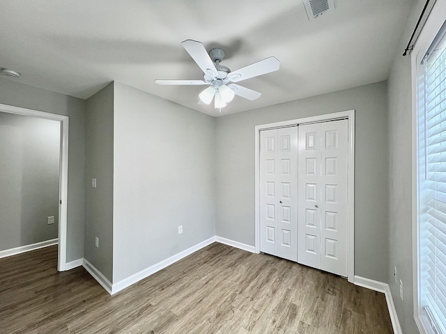 402 Pine St, Pulaski, TN 38478 - unfurnished bedroom with wood finished floors, baseboards, a closet, and ceiling fan