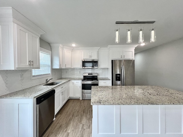 402 Pine St, Pulaski, TN 38478 - kitchen with stainless steel appliances, a sink, white cabinets, and wood finished floors
